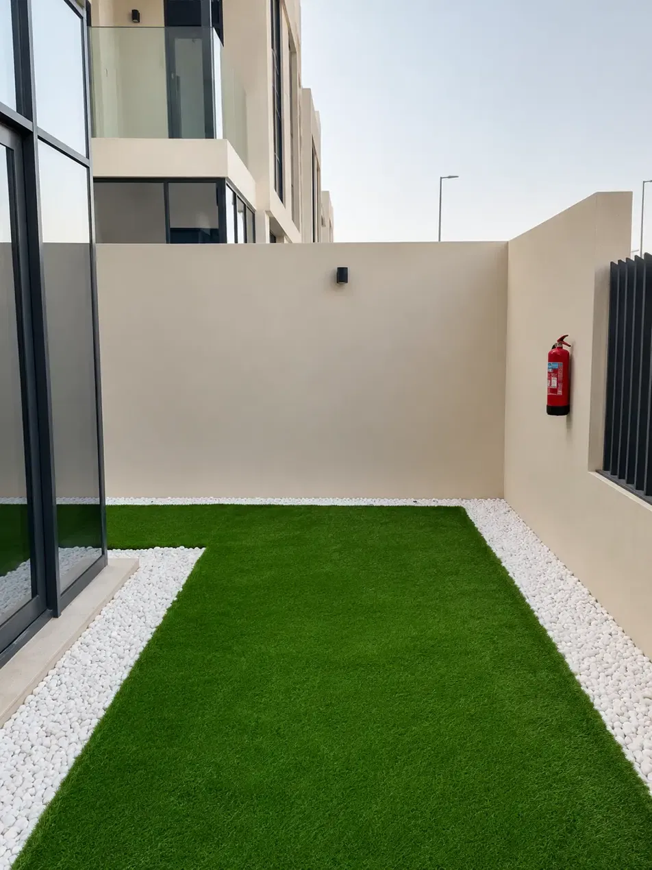 Landscaped villa garden with artificial grass and planting