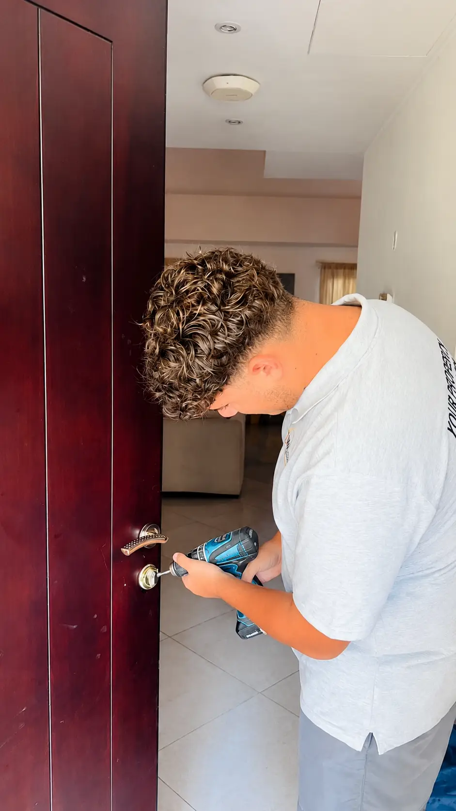 Technician repairing a door lock and handle