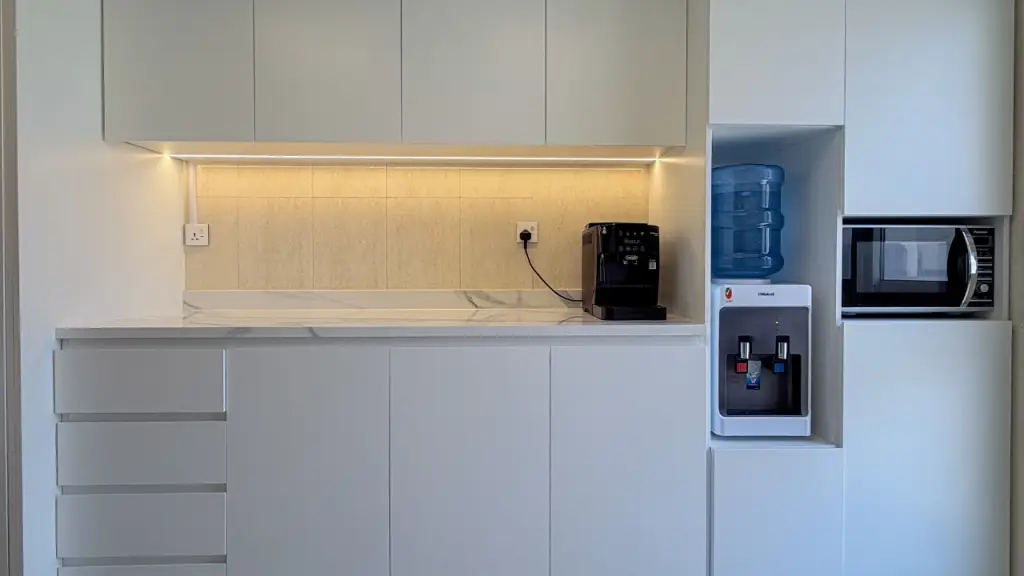 Bespoke white kitchen with full-height cabinetry and integrated appliances