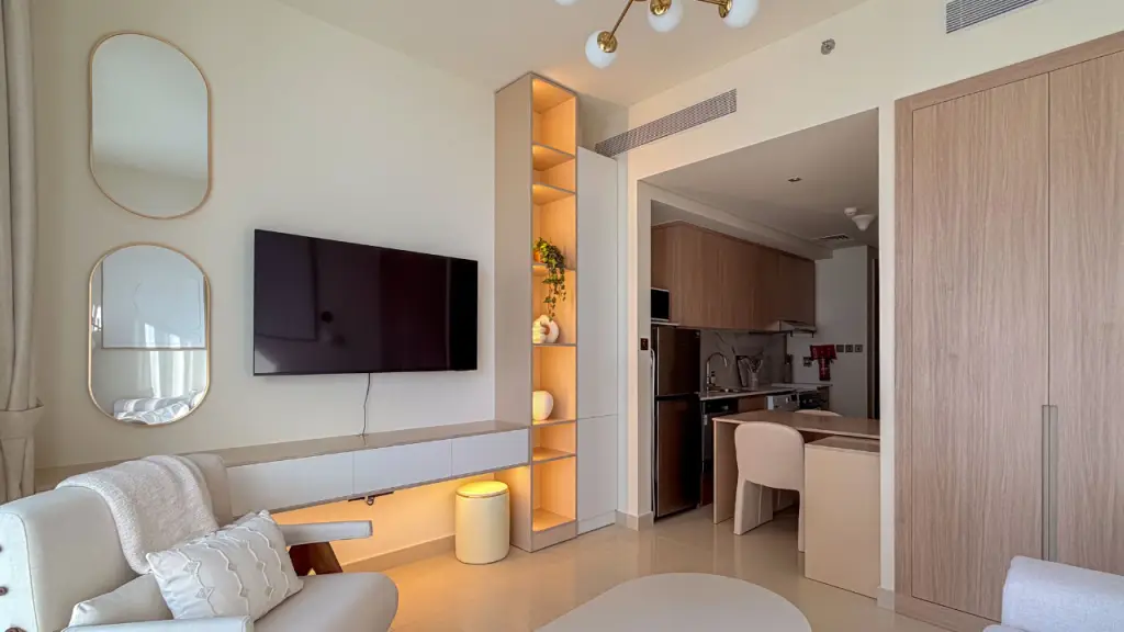 Compact apartment living room with a custom media and storage wall