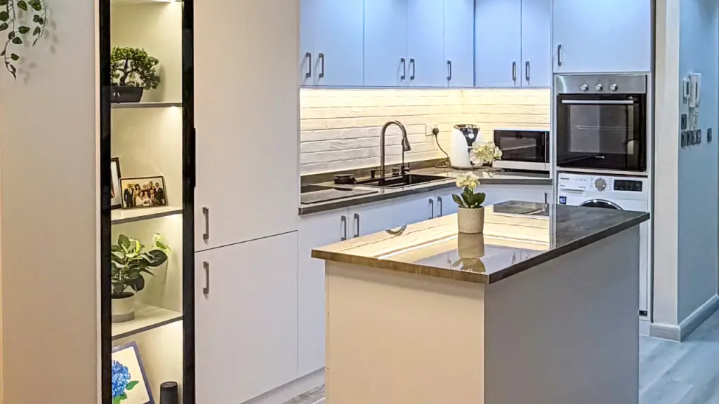 Contemporary white kitchen with a floating island and integrated shelving
